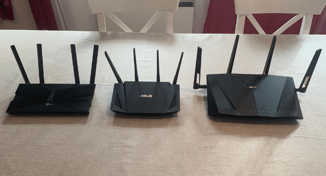 Tp Link AX50 ASUS RT AX3000 and the ASUS RT AX88U side by side